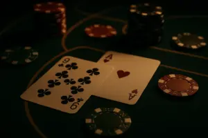 Close-up casino cards with subtle patterned edges, baccarat chips, and a dramatic gaming atmosphere